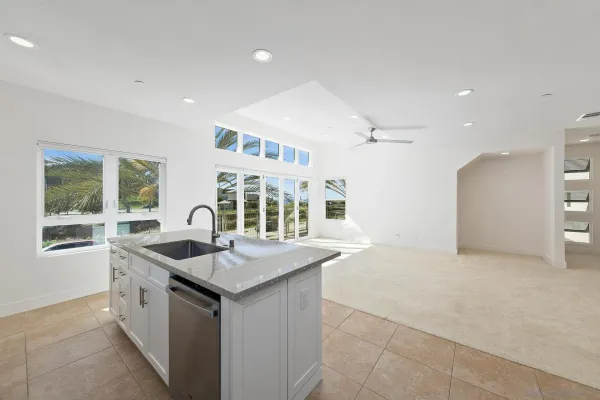 a kitchen with granite countertop a sink and a stove