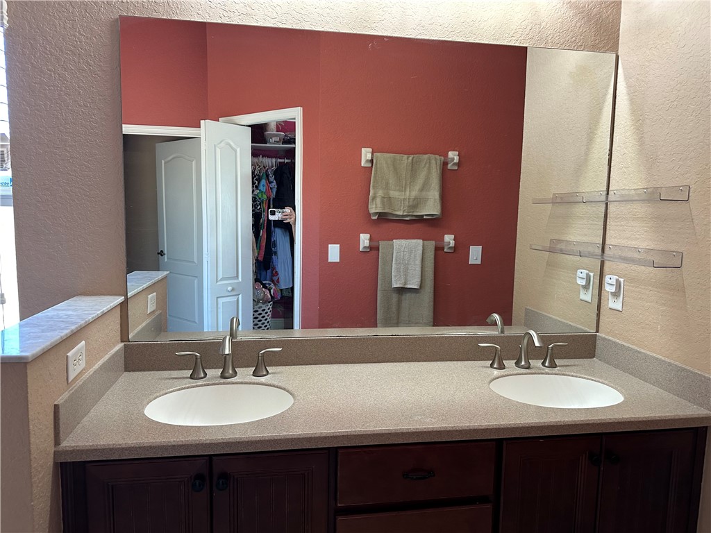 14650 87th Street Fellsmere, FL 32948 - Photo 23 of 36 a bathroom with a double vanity sink and a mirror