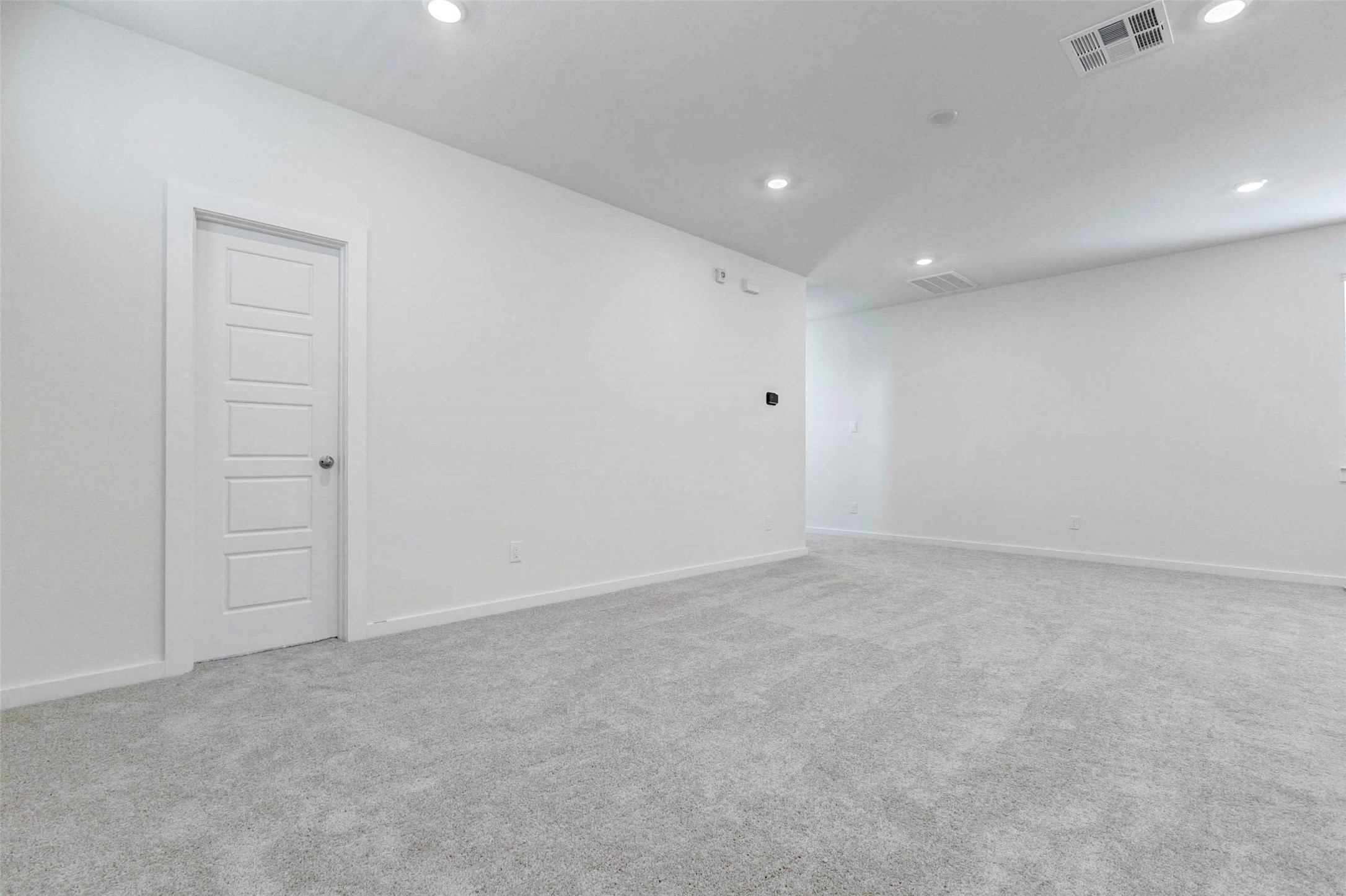 6471 Escondido Drive Rosharon, TX 77583 - Photo 11 of 33 Expansive living area with neutral carpet, bright white walls, recessed lighting, and an open layout that connects easily to the kitchen and entry spaces. This blank-slate room offers generous space for seating, media, décor, and everyday relaxation.