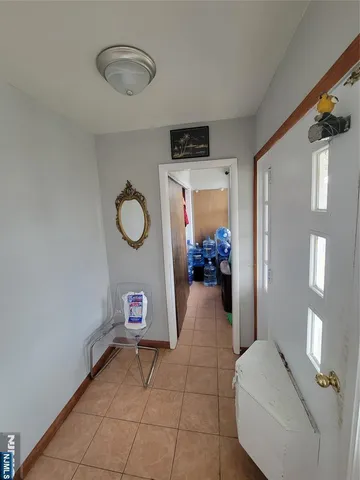 a view of a livingroom with an empty space and a window