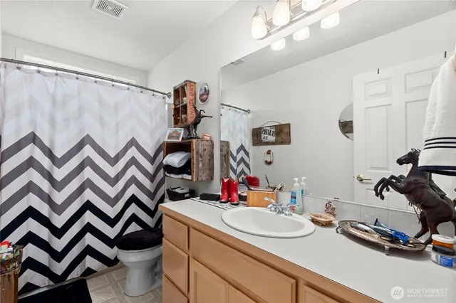 a bathroom with a sink toilet and a mirror