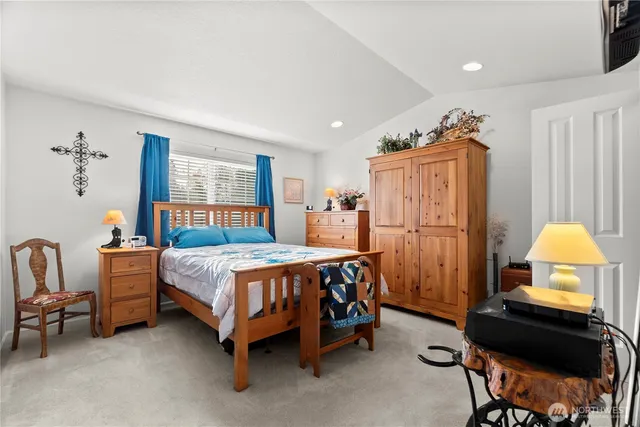 a bedroom with a bed chair and a window