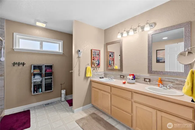 a bathroom with a sink double vanity and a mirror