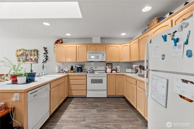 a kitchen with a white cabinets and white appliances
