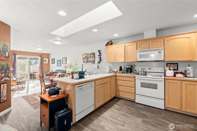 a kitchen with a stove sink and cabinets