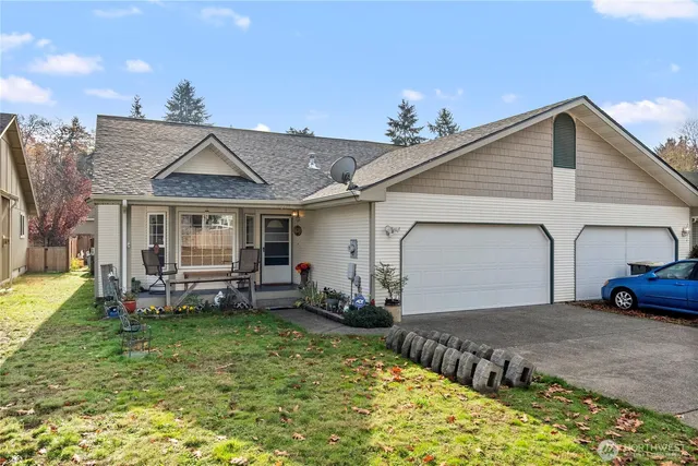 a view of a house with backyard porch and sitting area