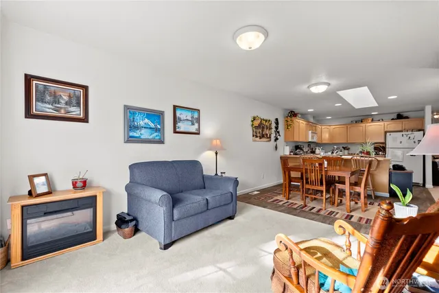 a living room with furniture and kitchen view