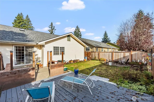 a view of a house with backyard and sitting area