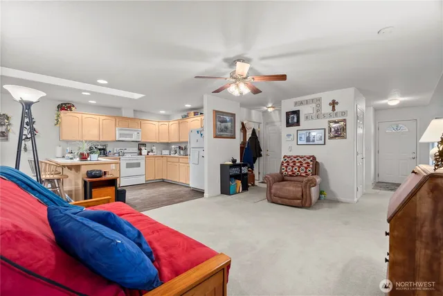 a living room with furniture and kitchen view