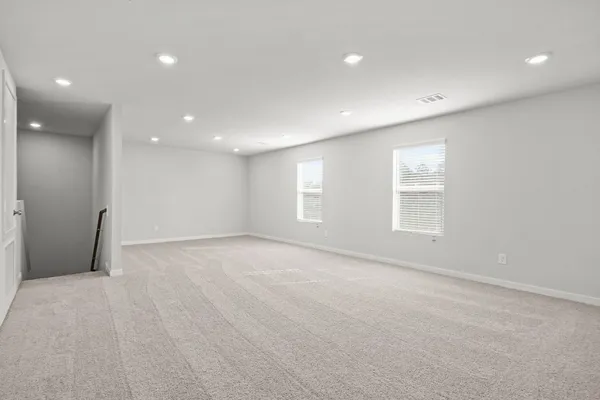 an empty room with windows and closet