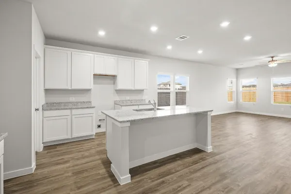 a kitchen with stainless steel appliances granite countertop a stove and a sink