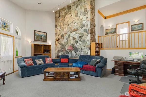 a living room with furniture and a baby crib