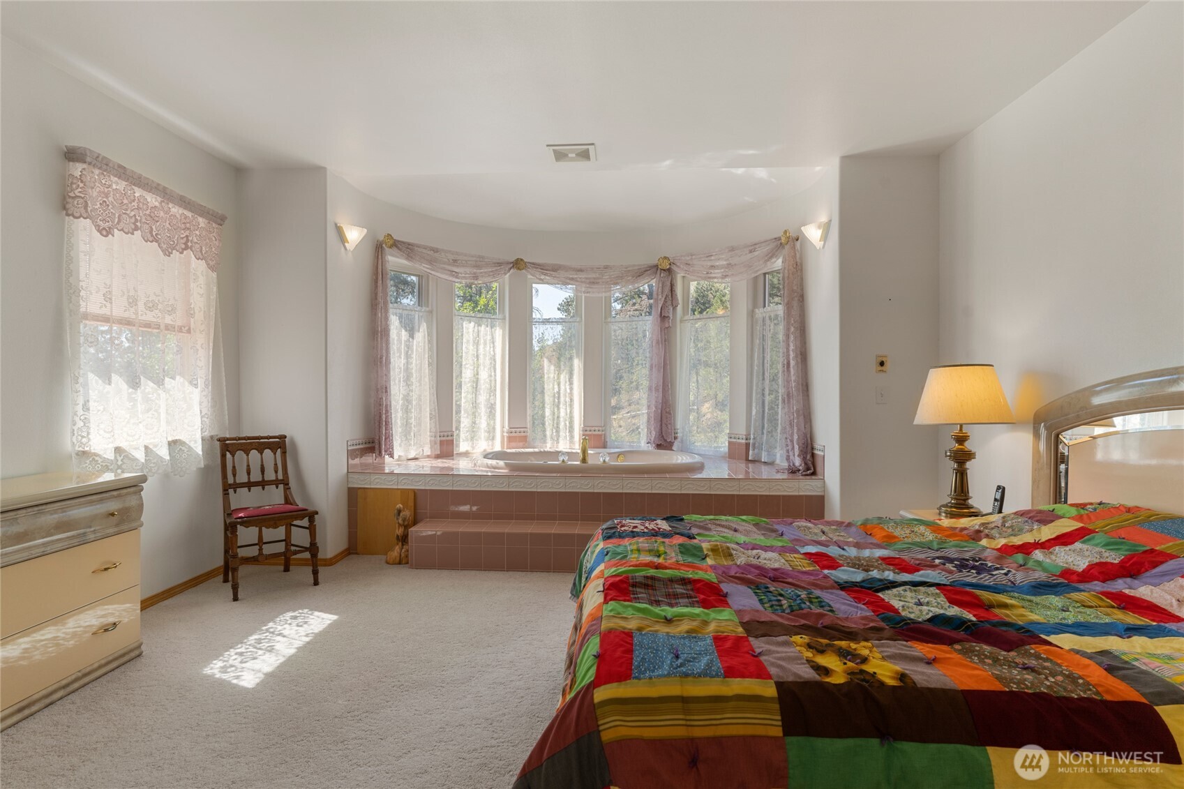 572 B W Chewuch Road Winthrop, WA 98862 - Photo 26 of 37 a bedroom with a bed and a lamp on dresser next to a window