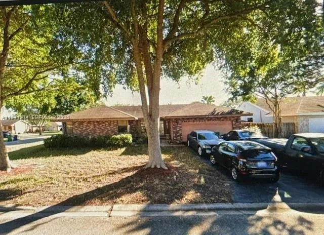 a couple of cars parked in front of a yard