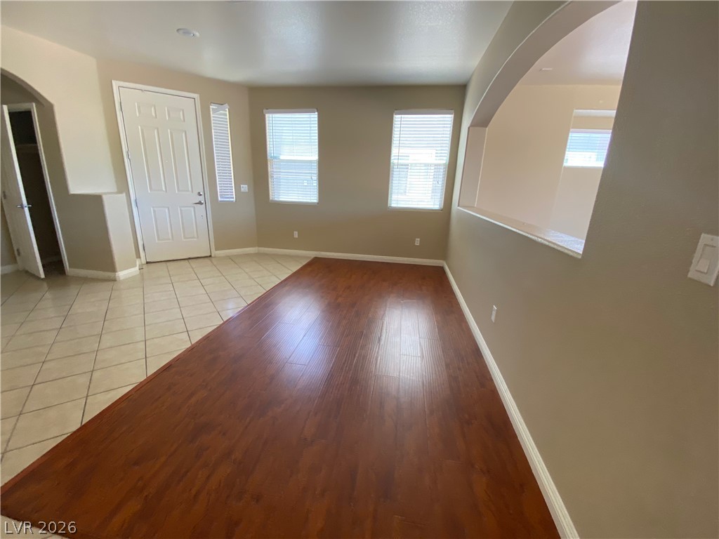 489 Foster Springs Road Las Vegas, NV 89148 - Photo 2 of 30 A welcoming entry area features warm wood flooring and convenient archways, ideal for an open concept layout.
