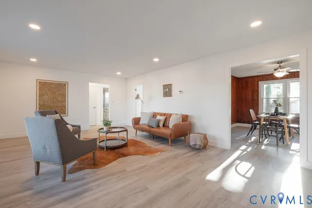 a dining room with furniture window and wooden floor