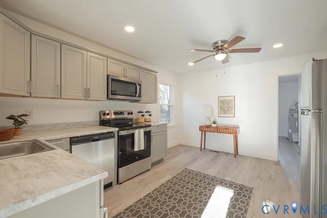 a kitchen with stainless steel appliances cabinets a sink and a window