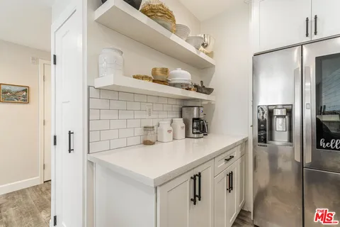 a kitchen with stainless steel appliances a sink and a refrigerator