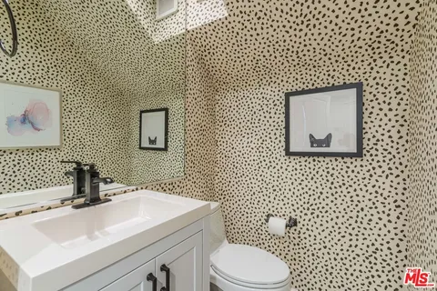 a bathroom with a sink toilet and mirror