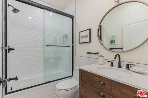 a bathroom with a toilet a sink and a mirror