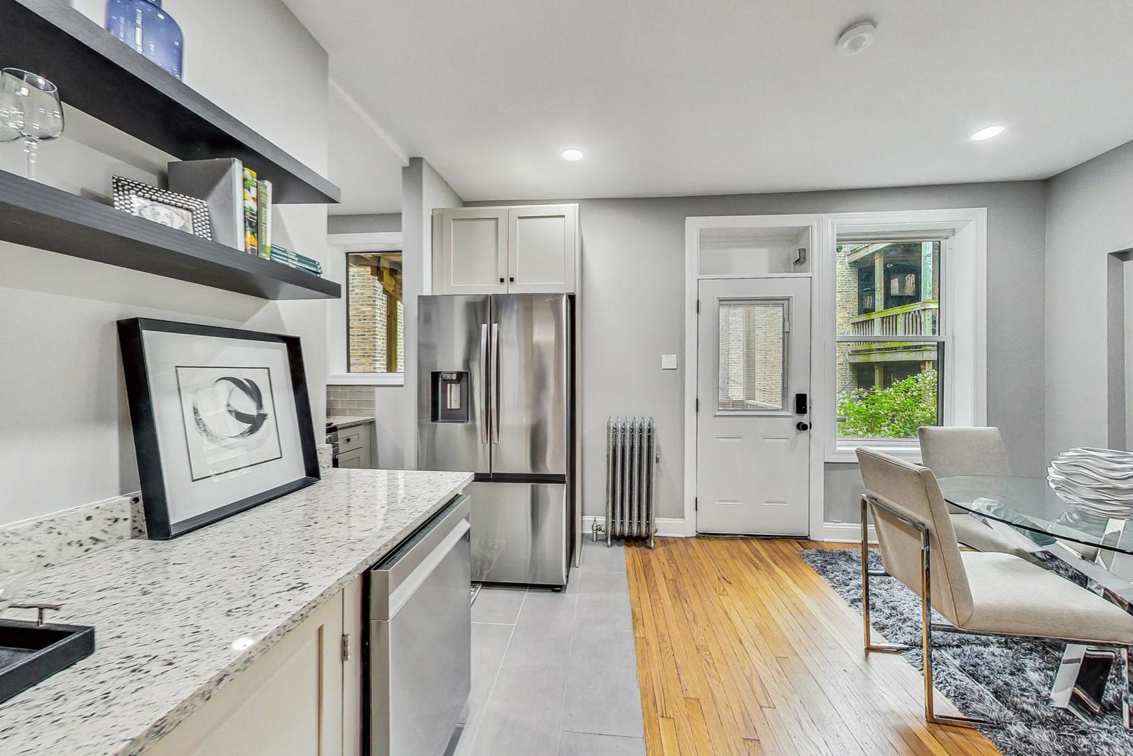 2108 North Seminary Avenue, Unit 5 Chicago, IL 60614 - Photo 6 of 16 a kitchen with stainless steel appliances granite countertop a refrigerator and a stove top oven
