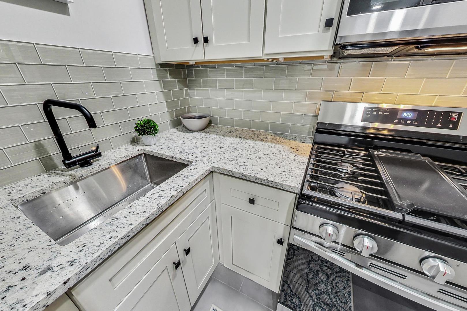 2108 North Seminary Avenue, Unit 5 Chicago, IL 60614 - Photo 8 of 16 a kitchen with granite countertop a stove and a sink