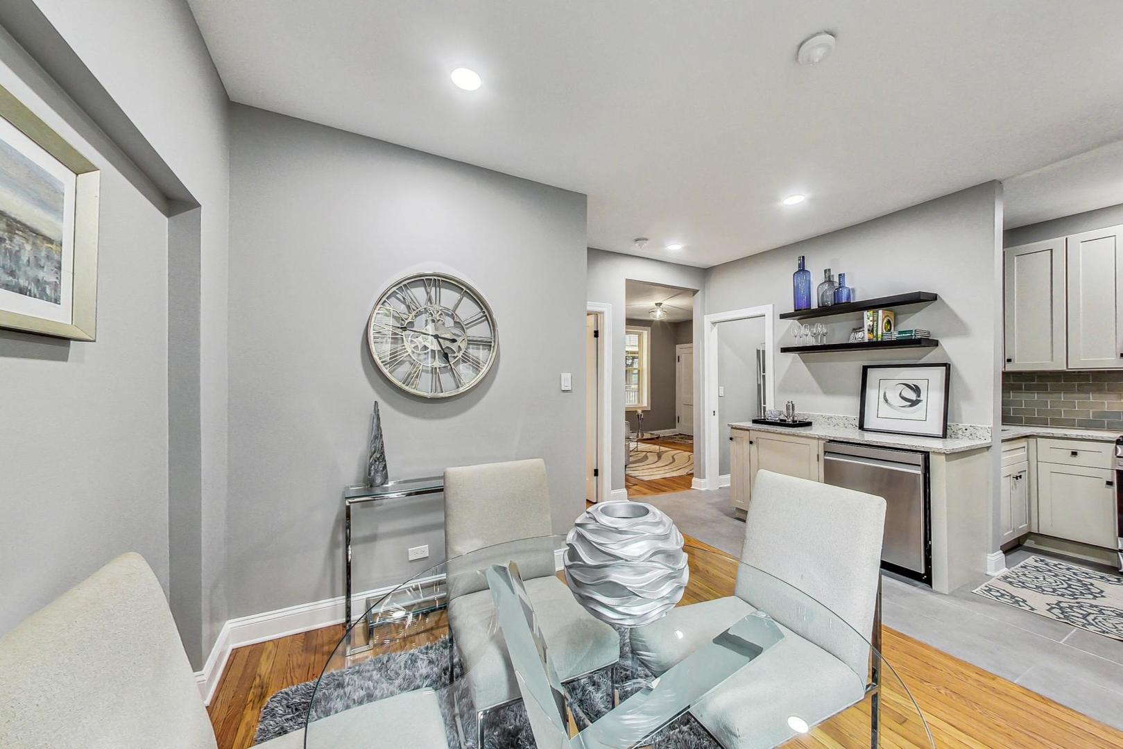 2108 North Seminary Avenue, Unit 5 Chicago, IL 60614 - Photo 10 of 16 a living room with furniture a clock and a view of kitchen