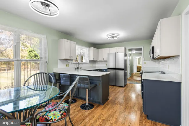 a bedroom with a beds and a flat screen tv