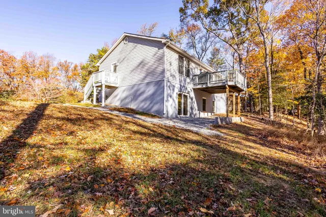 a view of a hallway with wooden floor and a fireplace