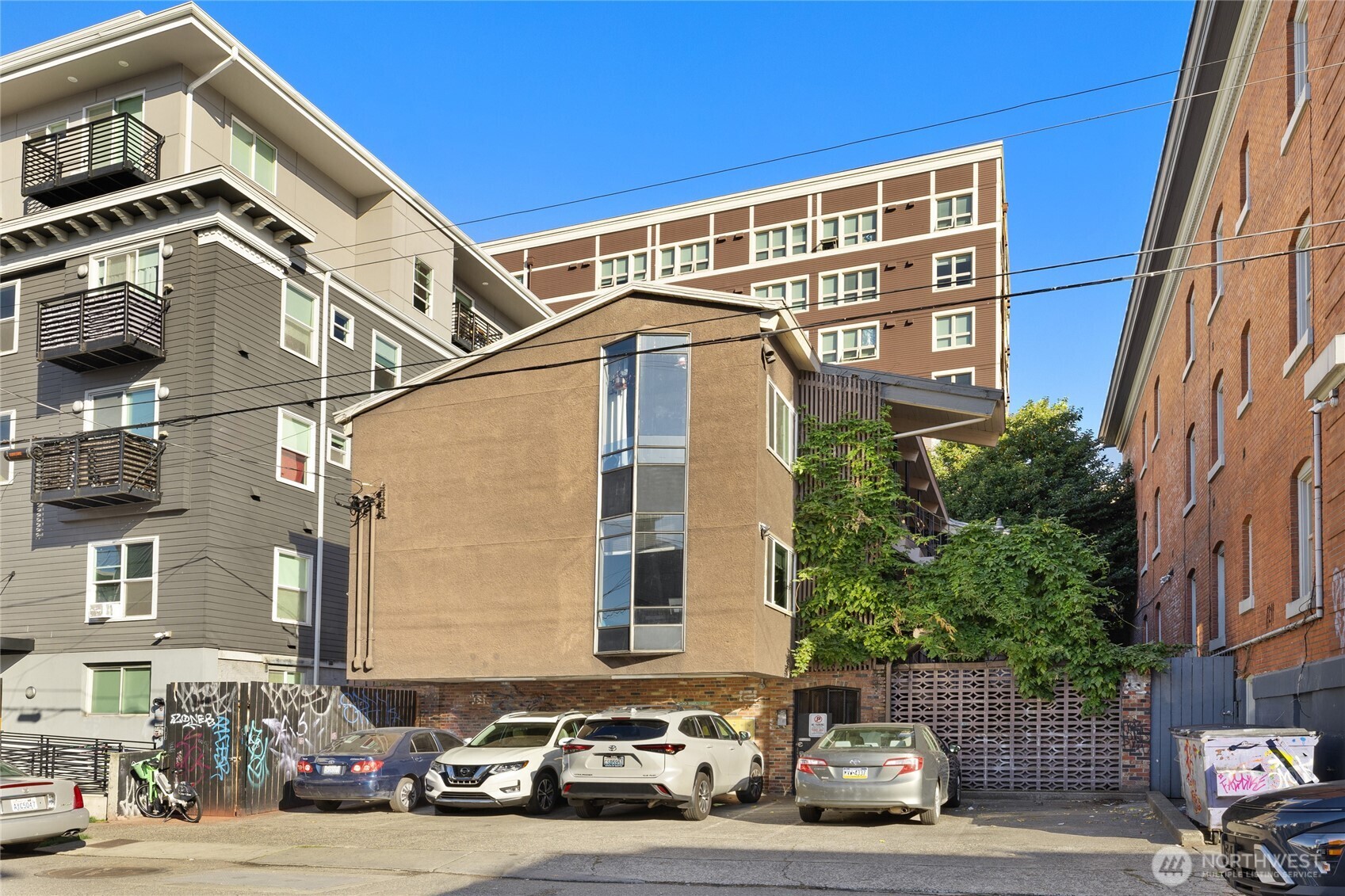 1718 Summit Avenue Seattle, WA 98122 - Photo 2 of 11 a front view of a building with lot of cars and trees