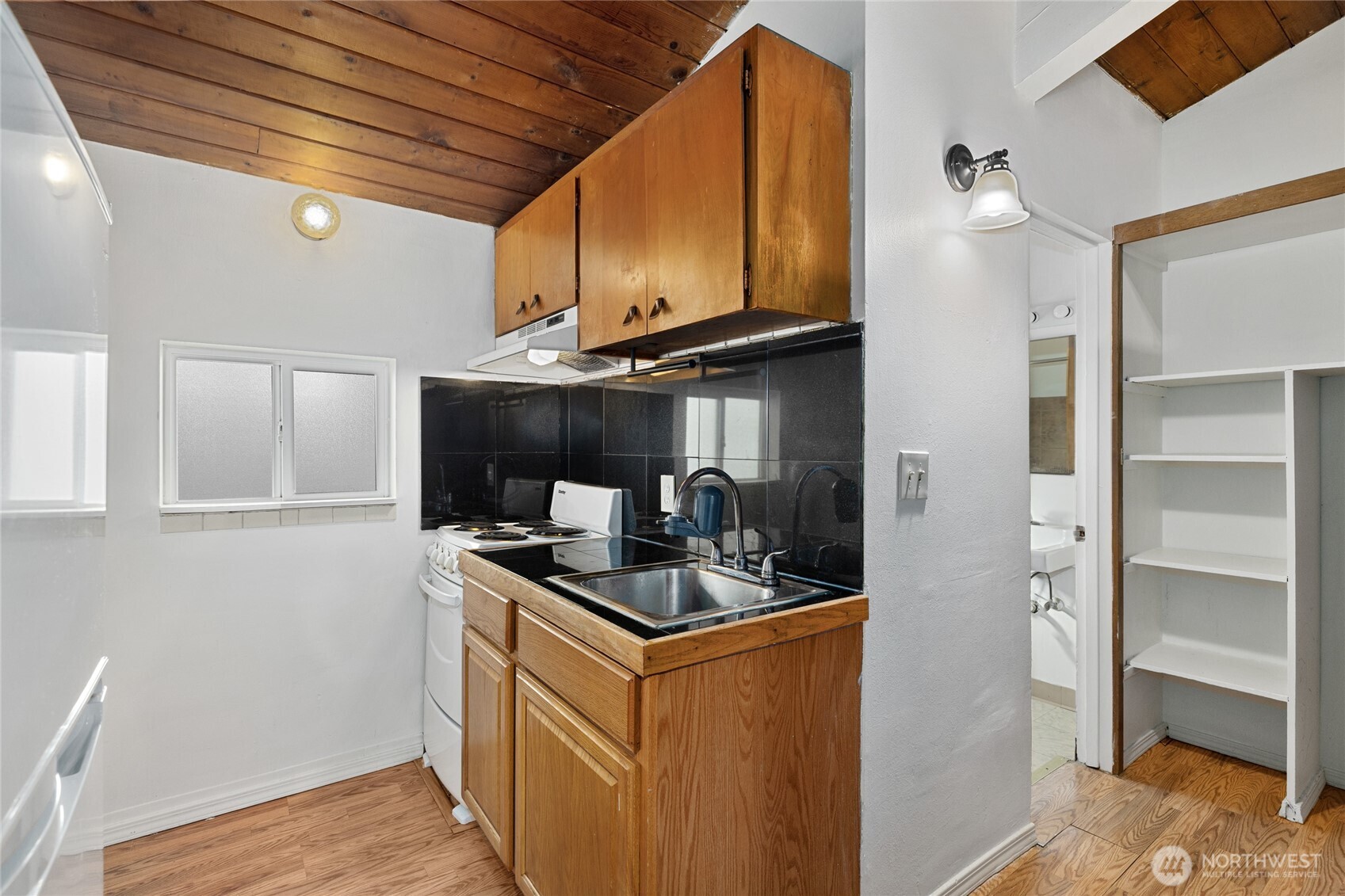 1718 Summit Avenue Seattle, WA 98122 - Photo 5 of 11 a kitchen with stainless steel appliances granite countertop a sink stove and cabinets