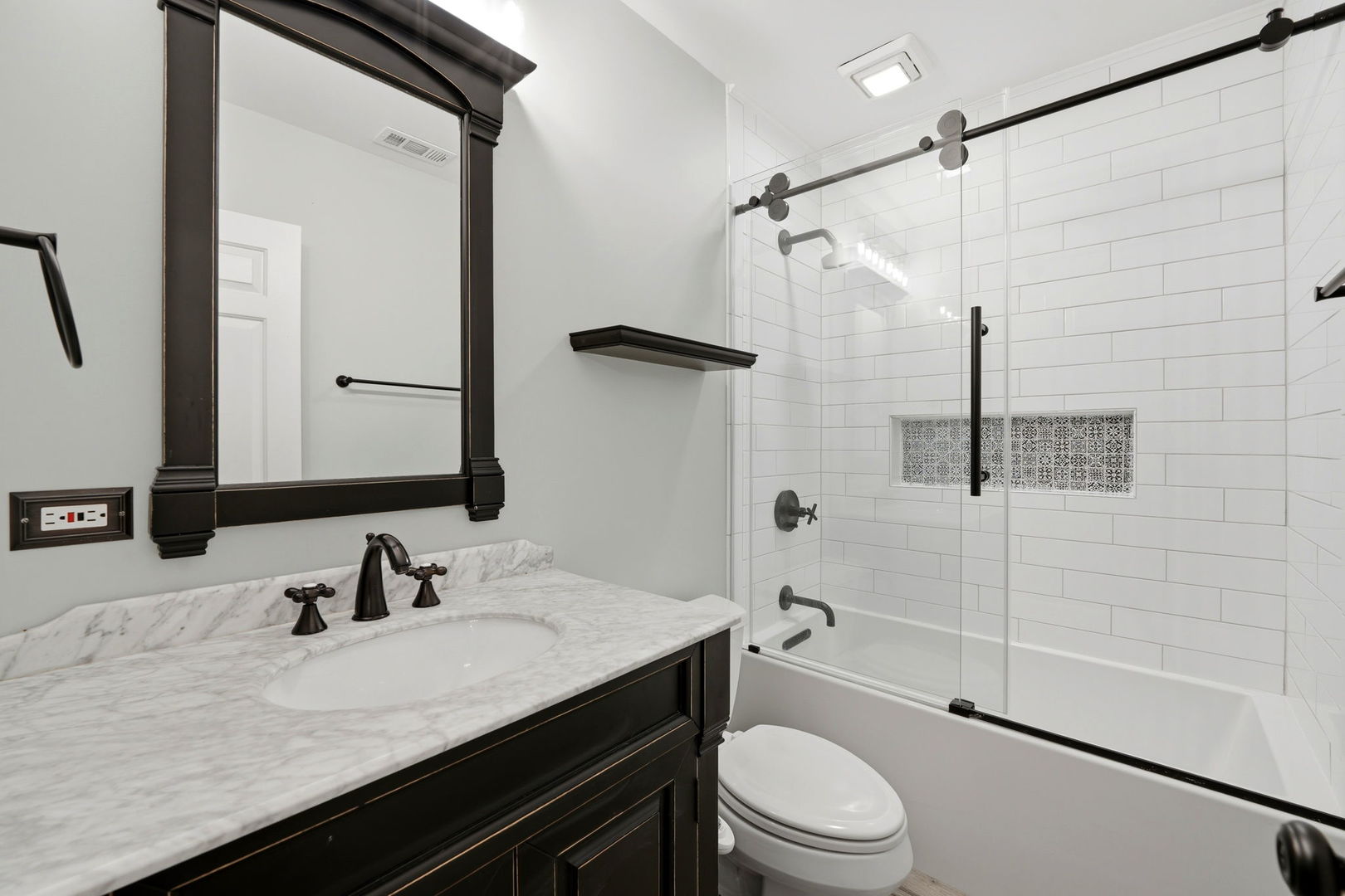 619 North Racine Avenue, Unit 1 Chicago, IL 60642 - Photo 22 of 36 a bathroom with a granite countertop sink toilet a mirror and shower
