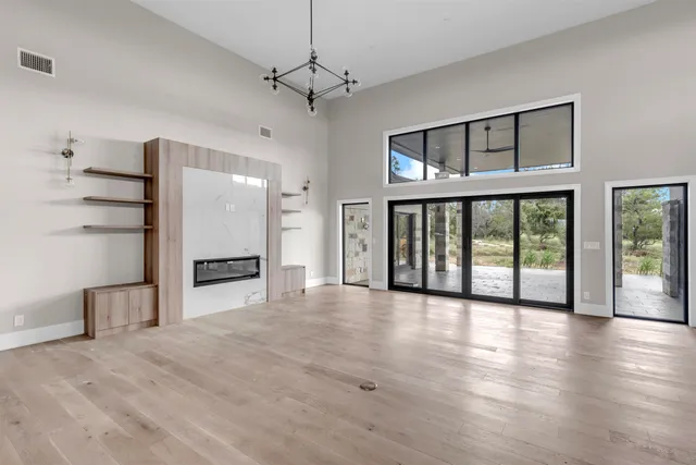 a view of a big room with windows and entryway