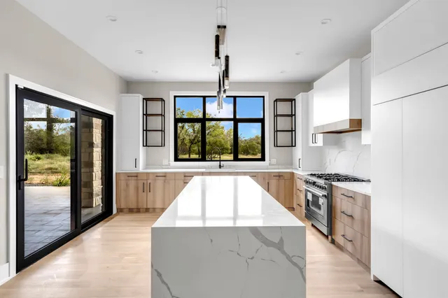 a kitchen with a stove a sink and a refrigerator