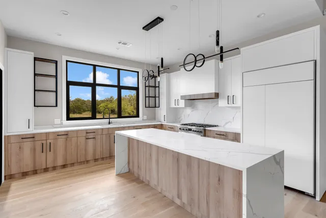 a kitchen with a stove a sink and a refrigerator