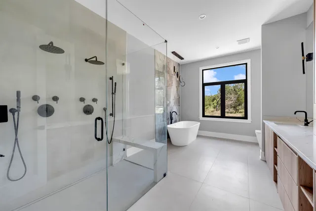 a spacious bathroom with a granite countertop sink a toilet and shower