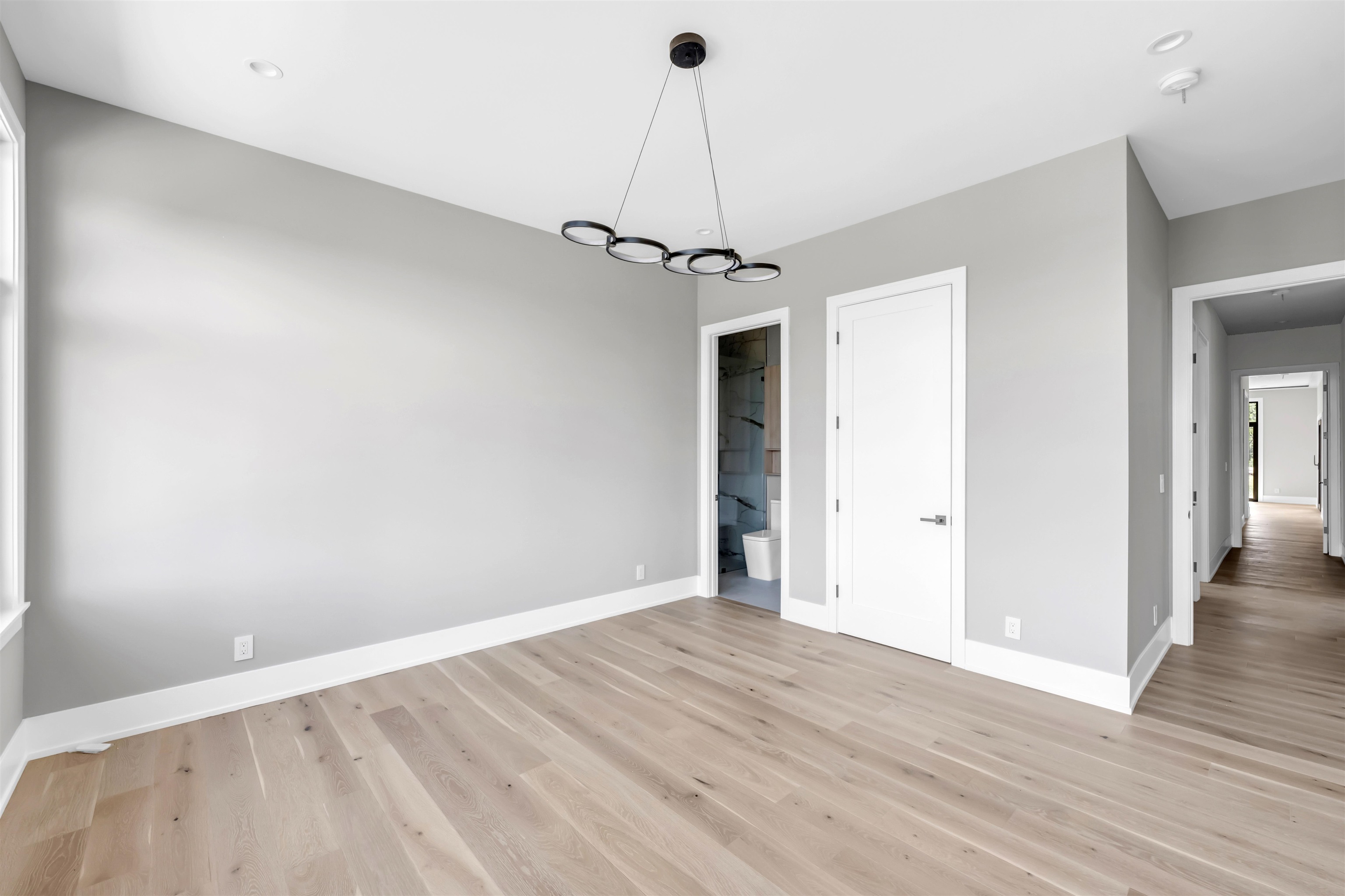 6507 Ranch Road 962 West Round Mountain, TX 78663 - Photo 22 of 28 a view of a room with wooden floor a ceiling fan and windows