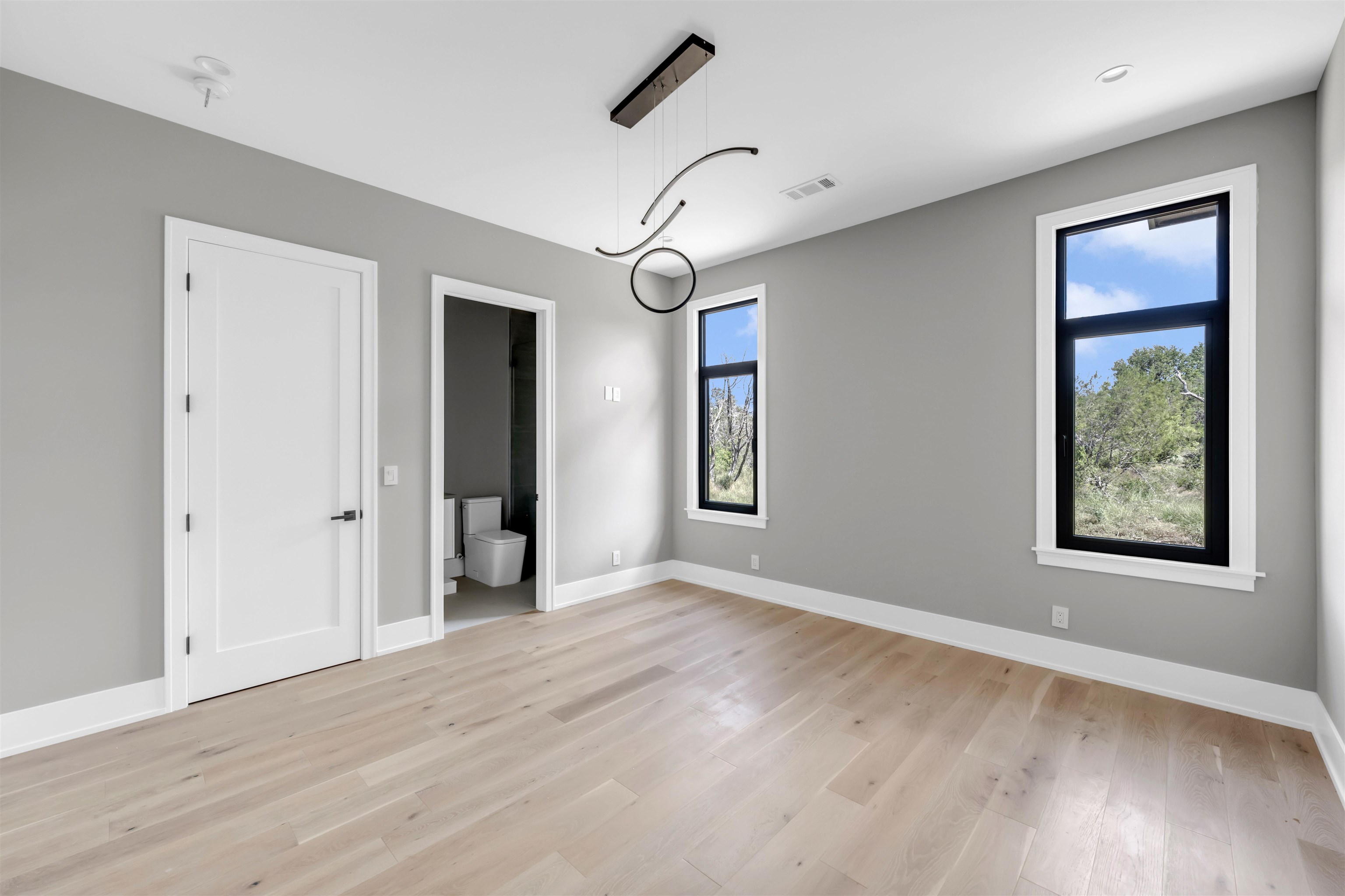 6507 Ranch Road 962 West Round Mountain, TX 78663 - Photo 24 of 28 a view of an empty room with wooden floor and a window