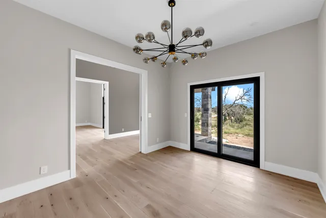 a view of a livingroom with a ceiling fan and window