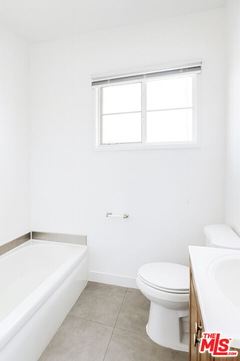 4062 Muirfield Road South, Unit C Los Angeles, CA 90008 - Photo 7 of 16 a white toilet sitting next to a white sink