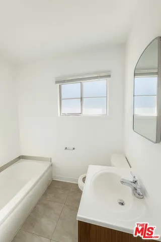 a bathroom with a bathtub and a sink
