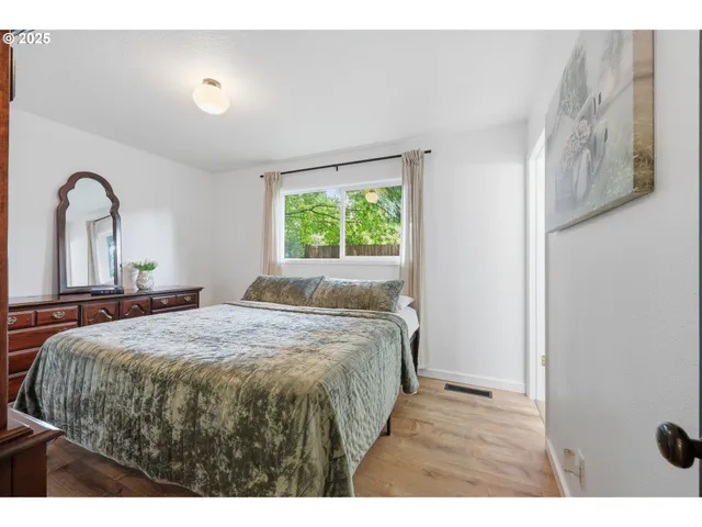 a bed sitting in a bedroom next to a window
