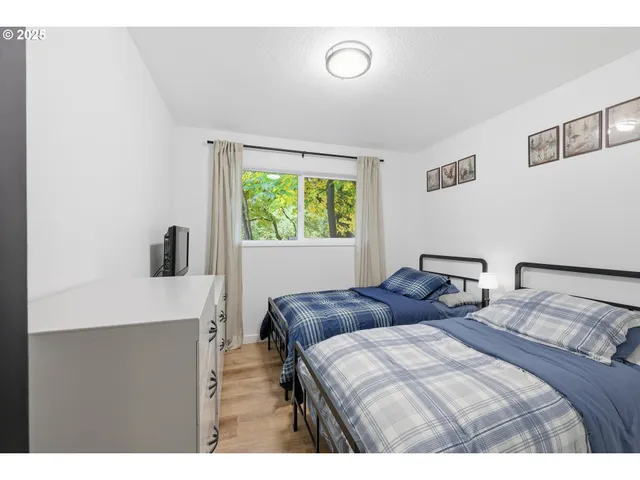 a bedroom with two beds and a window