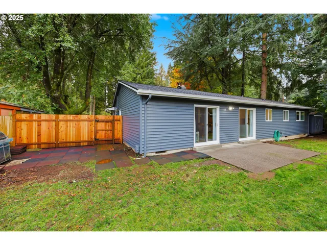 a view of backyard of house with green space