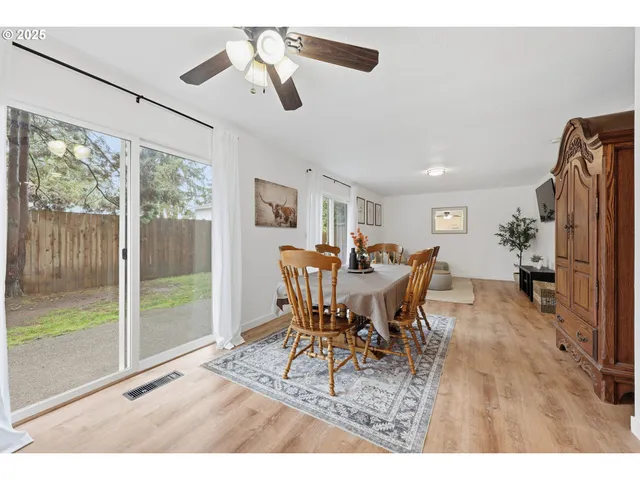 a dining room with furniture window and wooden floor