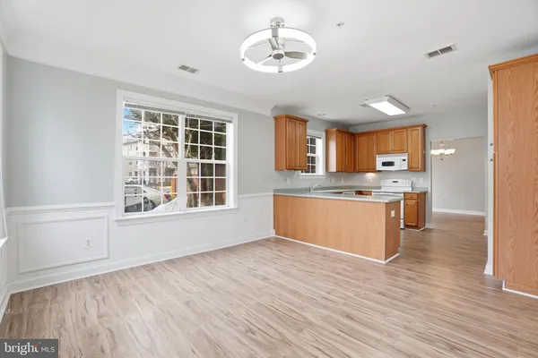 a view of kitchen with granite countertop cabinets and wooden floor