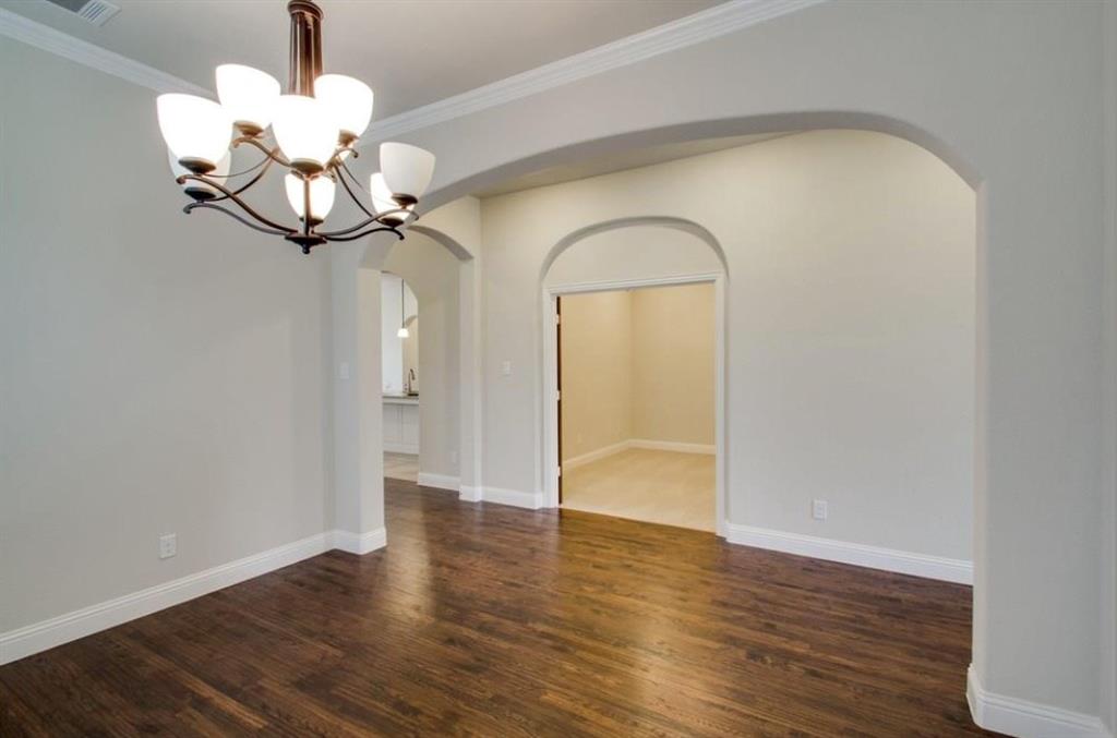 421 Prairie Run Aledo, TX 76008 - Photo 11 of 19 Unfurnished dining area featuring wood finished floors and crown molding