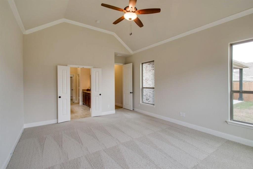 421 Prairie Run Aledo, TX 76008 - Photo 15 of 19 crown molding, lofted ceiling, light colored carpet, connected bathroom, and ceiling fan
