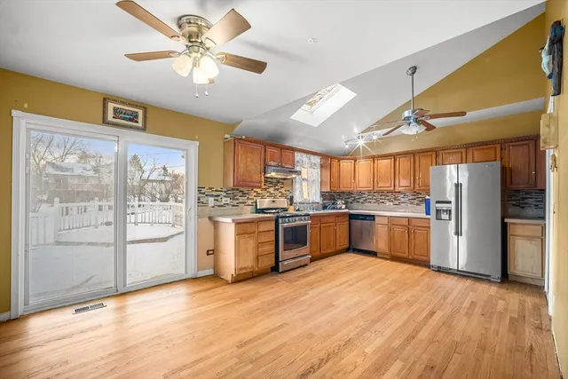 a kitchen with a refrigerator and cabinets