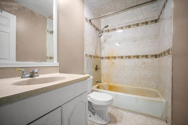 a bathroom with a sink a mirror toilet and bathtub